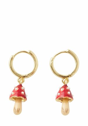 Gold hoop earrings featuring red mushroom charms with white polka dots and a small beige stem. The design is playful and whimsical.