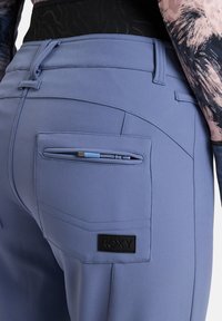 Roxy Damenhose aus weichem Lavendelstoff, mit einem Reißverschluss-Rückentasche, schwarzem Logo-Patch und einem taillierten Design mit detaillierter Nahtführung.