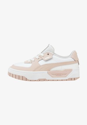White and light pink sneakers with a textured surface, padded collar, and robust outsole. Features a prominent side logo and heel tab.