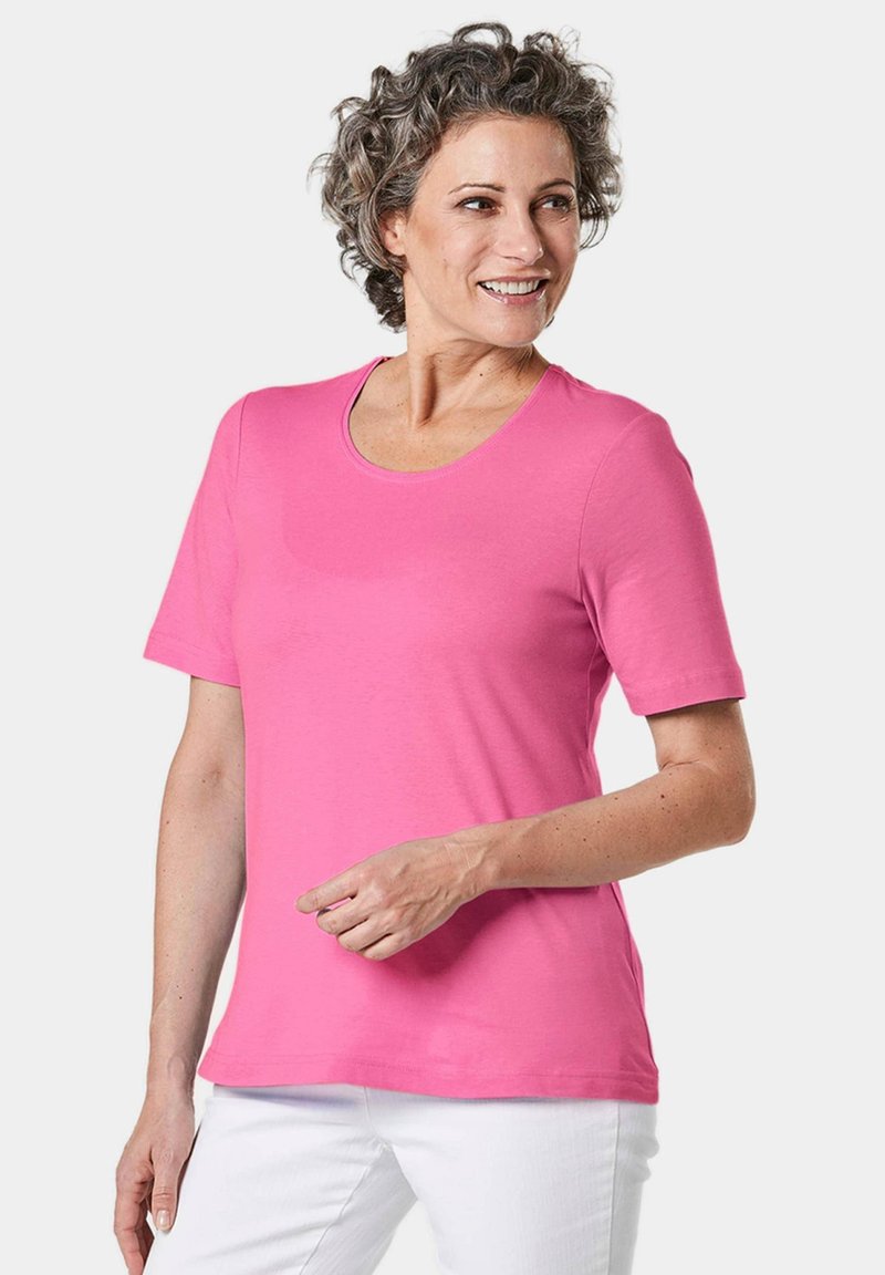 Korte mouw, T-shirt met ronde hals in felroze, gemaakt van zachte stof. Heeft een relaxte pasvorm en een gladde textuur. Geen opvallende patronen of accenten.