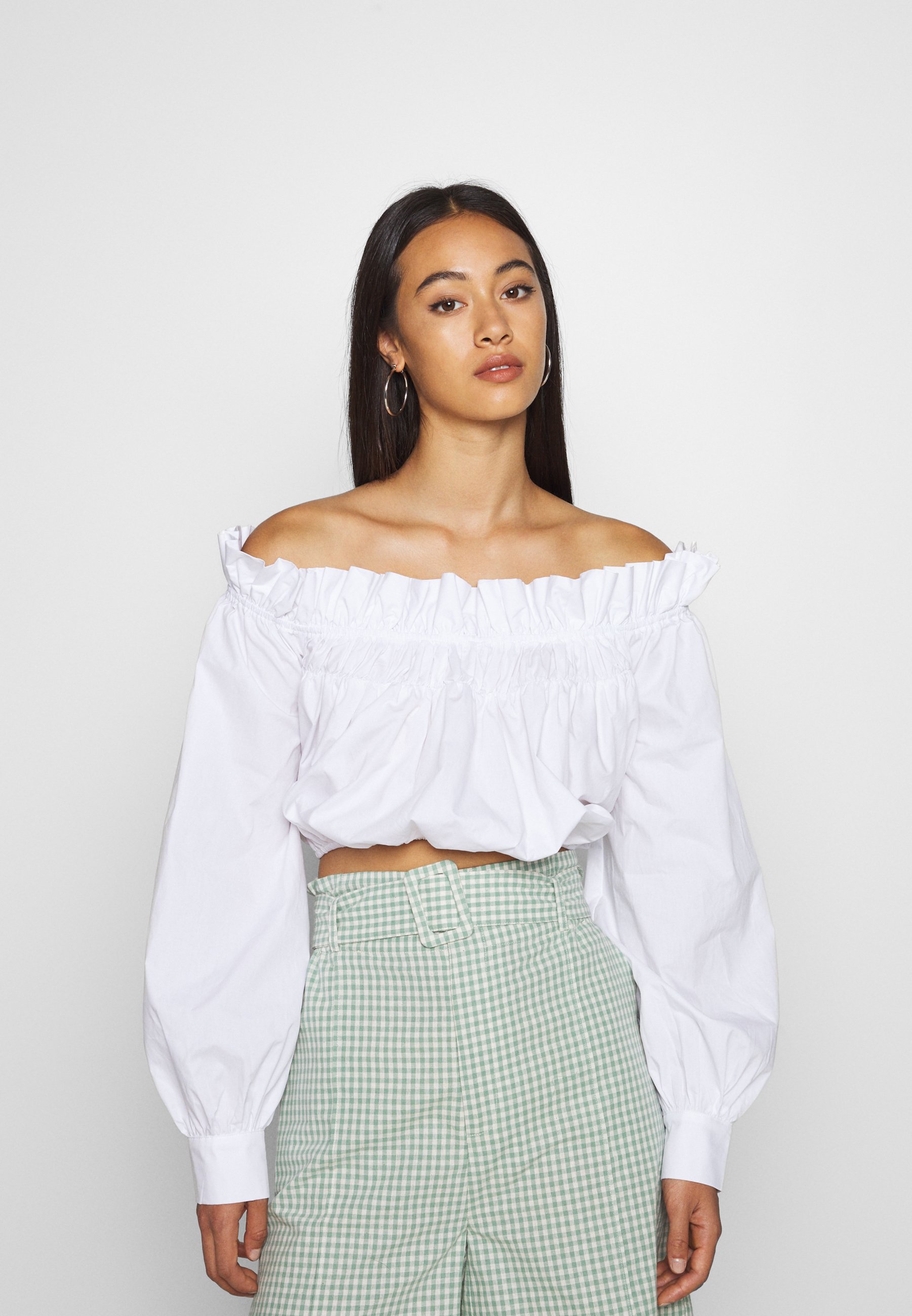 white shoulderless blouse
