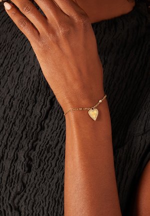 GUESS Bracelet Dreaming - Acier Doré élégant - Modèle JUBB03125JWYGS