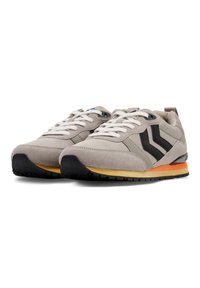 Sneakers with a grey suede and fabric upper, black accents, white laces, and a multicolored sole featuring orange and yellow details.