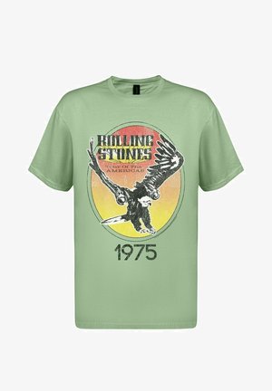 Svetle zelené bavlněné tričko s grafikou orla, retro-stylem textem "Rolling Stones" a rokem "1975" v černém detailech.