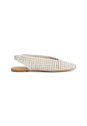 Cream woven slingback flat shoe with pointed toe and wooden sole shown against white background.