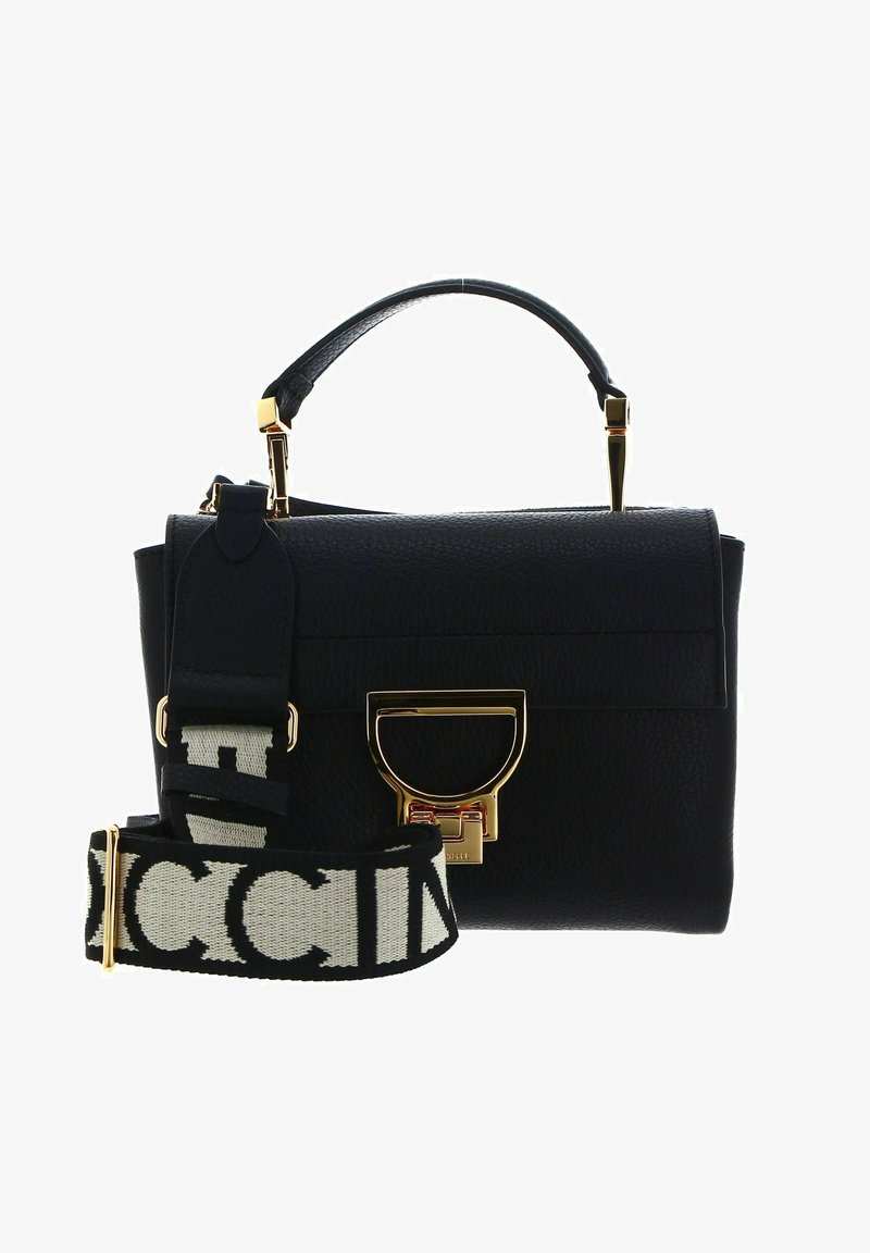 Black leather handbag with a structured design, gold hardware, and a removable strap featuring a bold white pattern.