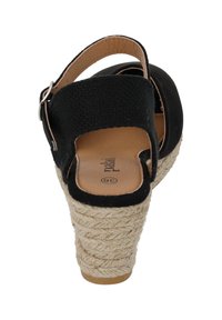 Sandalo espadrilla nero con tacco a zeppa in juta intrecciata, design aperto sul retro e cinturino alla caviglia regolabile con fibbia metallica.