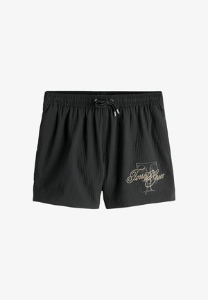 Shorts de bain noirs à côtes avec taille élastique, cordon de serrage et logo script "Torres Greco" sur la partie inférieure de la jambe gauche.