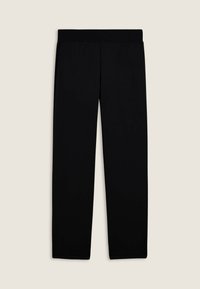 Leggings negros y elásticos con una cinturilla ancha y plana. Textura suave y diseño ajustado sin patrones ni hardware visible.