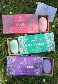 Bronnley soap boxes in pink, green, and purple; decorated with floral patterns. Each box contains a matching colored soap bar.