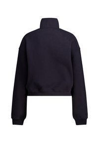 Lyhytmustavillapaita, jossa on korkea kaulus, pitkät hihat ja ribattu lähtöosa. Valmistettu tekstuuri-kankaasta, jossa on sileä pinta.