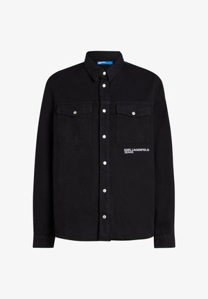 Juodas ilgarankovis marškinis su spaudėmis, dviem krūtinės kišenėm su spaudėmis ir "Karl Lagerfeld Jeans" logotipu dešinėje kišenėje.