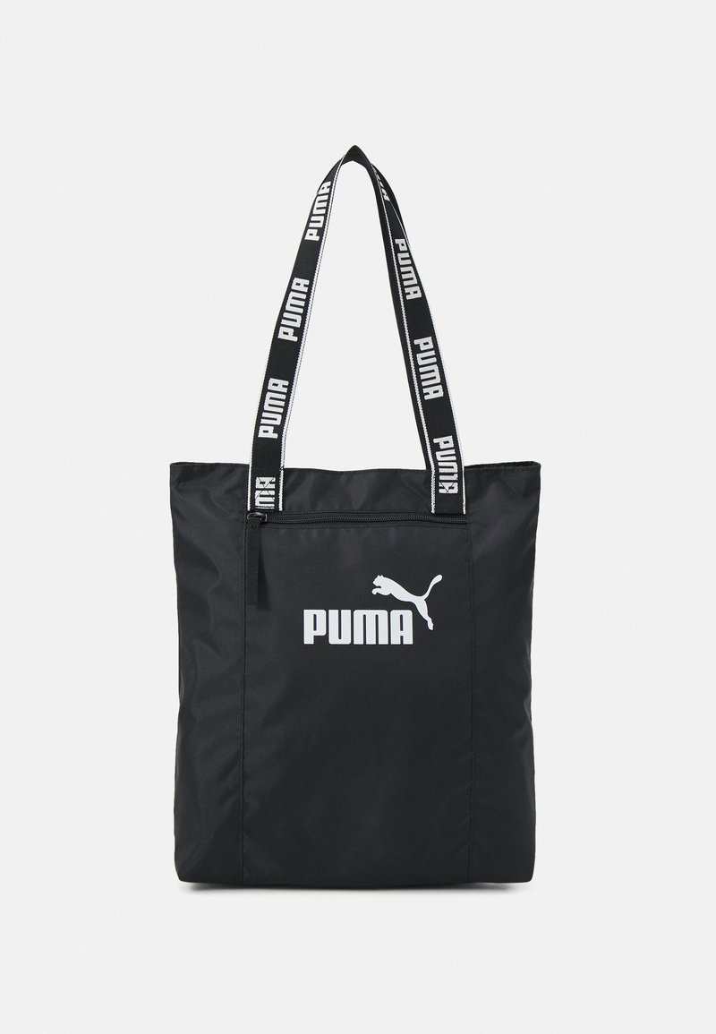 Zwarte nylon draagtas met dubbele handvatten. Voorzien van een wit PUMA-logo en kattensilhouet. Met ritssluiting aan de bovenkant. Versterkte stiksels.