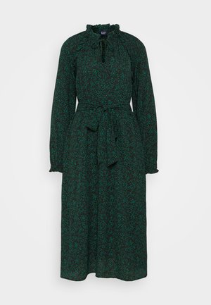 Roheline lilleline kleit, millel on volangidega kaelus, pikad varrukad, nööriga vöö talje kohal ja voolav disain. Kangas on pehme tekstuuriga.