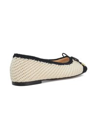 Flat shoe with a woven beige upper, black trim, and a pointed toe. Features a small black bow and a smooth black sole.