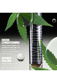 Clear tube of Milk Makeup brow product surrounded by green hemp leaves and droplets with text about brow conditioning and defined volume.