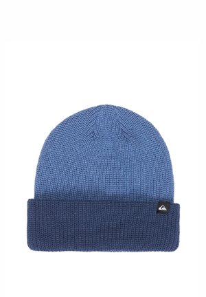 Blue knitted beanie hat with a folded cuff and a small black logo tag on the side against a white background.