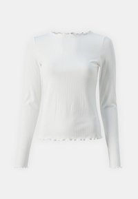 Long-sleeve white top in ribbed fabric with a straight silhouette. Features a scalloped neckline and hem, adding texture to the design.