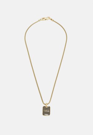 Gouden ketting met een rechthoekige zwarte hanger, met het woord "GUESS" in een vet lettertype. Gladde textuur, minimalistisch ontwerp.