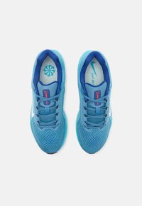 Zapatillas deportivas azules con una parte superior de malla, acentos en azul oscuro contrastantes, cordones planos, un logo blanco y una suela acolchada.