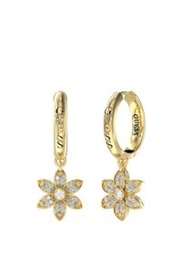 Goldene Creolen mit floralem Design, verziert mit klaren Kristallen. "GUESS"-Markierung ist an der Creole sichtbar.