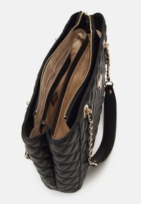 Quilted black handbag with gold hardware and chain accents. Features multiple compartments, zip closures, and a soft inner lining.