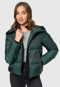 Padded green jacket featuring a zip front, two side pockets, and a hood with black accents. Made of shiny, lightweight material.