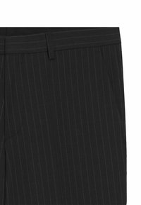 Schwarz gestreifte Hose mit glatter Textur, ausgestattet mit einem eng anliegenden Bund und seitlichen Taschen. Vertikale Streifen betonen das maßgeschneiderte Design.