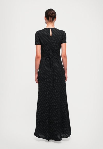 Black maxi dress with short sleeves, vertical white stripes, and a back keyhole cutout. Ties at the waist for a fitted look. Smooth texture.