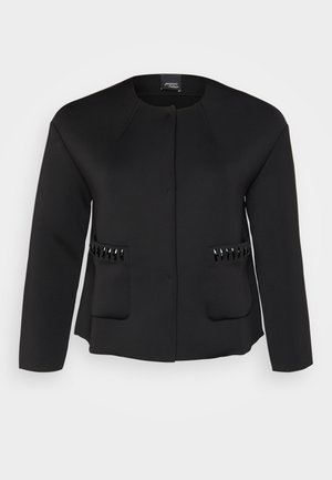 Black jacket made of smooth fabric, featuring a round neckline, two front pockets, and glossy black accents on the pockets.