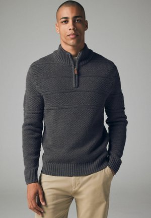 Knitted dark gray pullover sweater with a high collar and half-zip front, featuring textured patterns and ribbed cuffs and hem.
