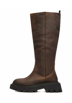 Bota alta de cuero marrón con suela gruesa negra de tipo lug, costuras en el tobillo y la pantorrilla, y pequeño logo "G-STAR" cerca del borde superior.