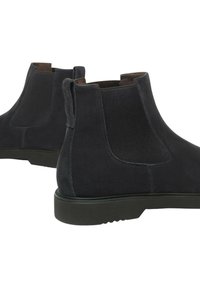 Un paio di stivali Chelsea in camoscio nero con pannelli elastici laterali e linguette, mostrati su uno sfondo bianco.