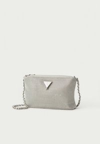 Small silver mesh crossbody bag with chain strap and triangular metal logo plaque, set against a white background.