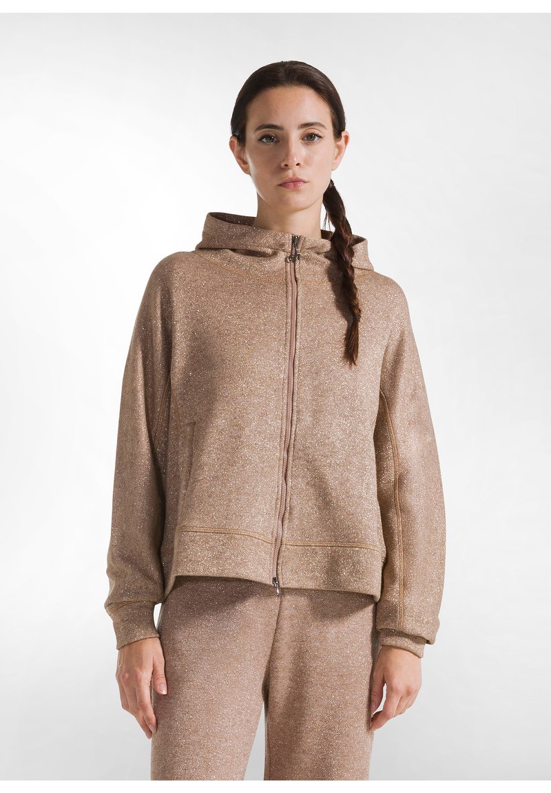 Lös passform, glittrande brun zip-up hoodie med huva, kängurufickor och ribbade muddar, tillsammans med matchande byxor. Slät textur.