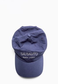 Navy blue cotton baseball cap featuring "SAUSALITO" and "MARIN COUNTY" embroidered in white, with a curved visor and ventilation holes.
