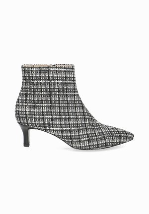 Black and white tweed ankle boots with a pointed toe and 4 cm stiletto heel. Textured pattern with a fitted shaft.