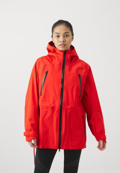 Red waterproof jacket featuring a hood, two zippered front pockets, and adjustable hem; made from smooth, lightweight material.