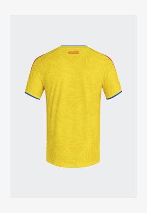 Gelbes Trikot mit einem dezenten Schmetterlingsmuster, blauen Akzenten an den Ärmeln und dem aufgestickten Schriftzug "COLOMBIA" am Nacken hinten.