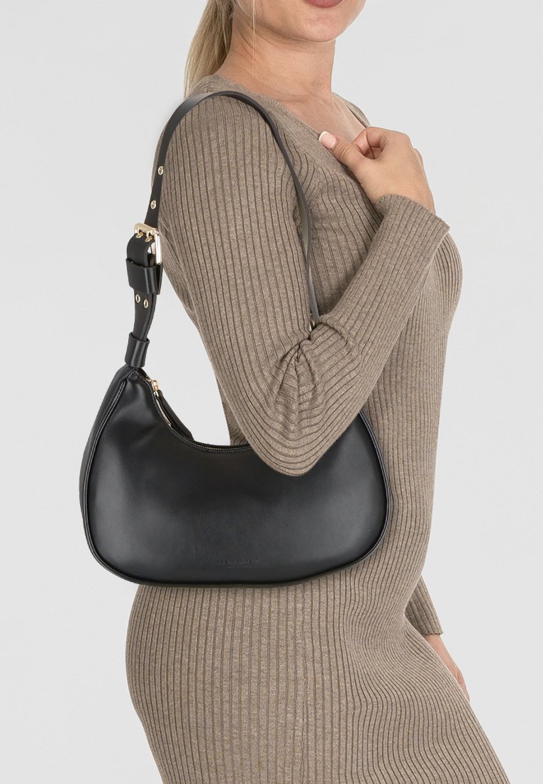 Borsa a spalla in pelle nera con forma curva, hardware dorato e tracolla staccabile. Texture liscia con un sottile dettaglio di branding.