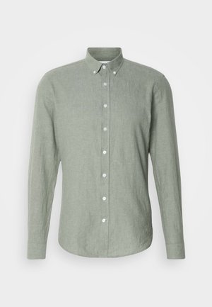 Világoszöld, hosszú ujjú gombos ing, texturált anyagból készült, gallérral, teljes hosszúságú gombolással és kerekített aljjal.