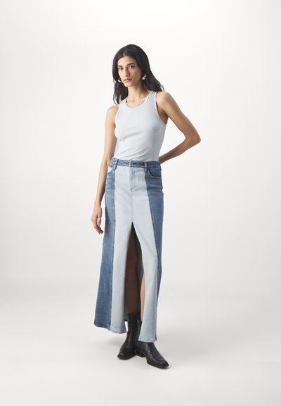 Light blue denim maxi skirt featuring a front slit, a mix of darker and lighter denim panels, and a high-waisted design.
