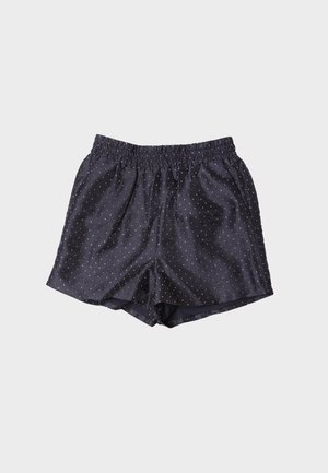 Tengerészkék szatén rövidnadrág elasztikus derékpánttal és kis fehér pöttyökkel. Laza szabású és sima textúrájú.