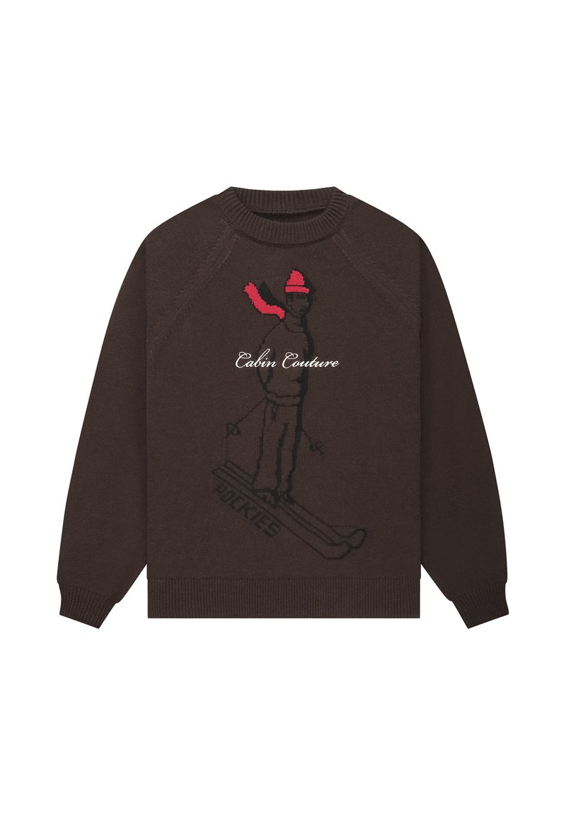 Brązowy sweter z dzianiny z grafiką narciarza w różu i czerni oraz napisem "Cabin Couture". Golf i mankiety ściągane, luźny krój.