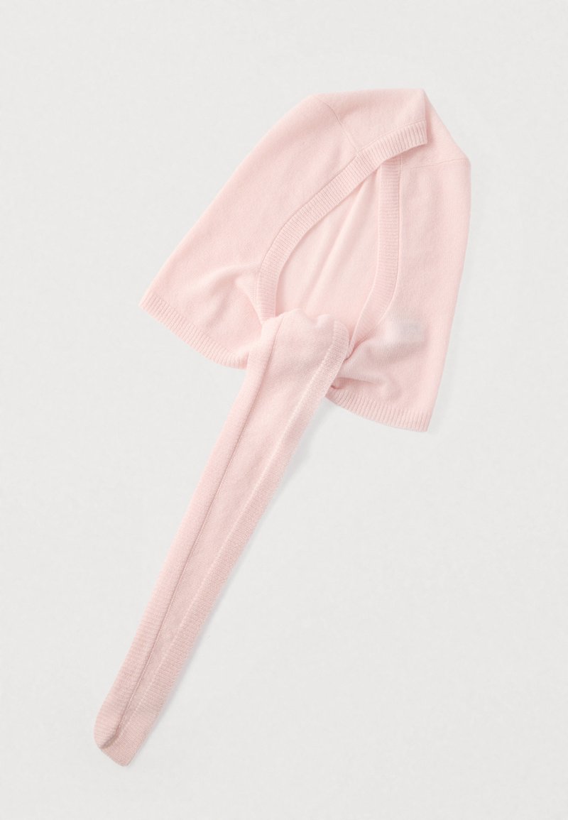 Pale pink seamless knit hat with a long, tapered tail. Soft texture, rounded shape, and ribbed edges. Suitable for various head sizes.