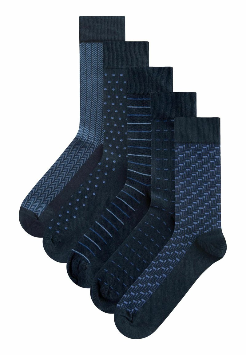 Five pairs of dark blue socks with various patterns: herringbone, polka dots, stripes, and geometric designs. Different textures and shades.