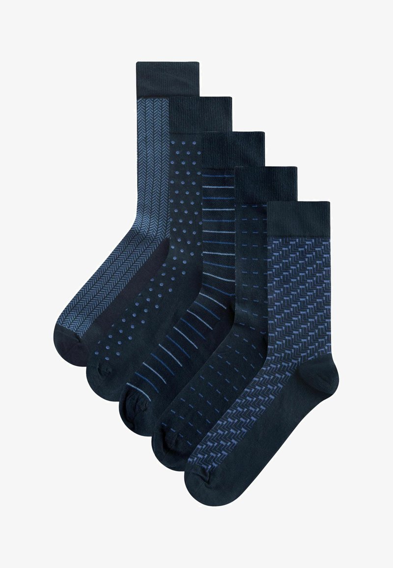 Five pairs of dark blue socks with various patterns: herringbone, polka dots, stripes, and geometric designs. Different textures and shades.