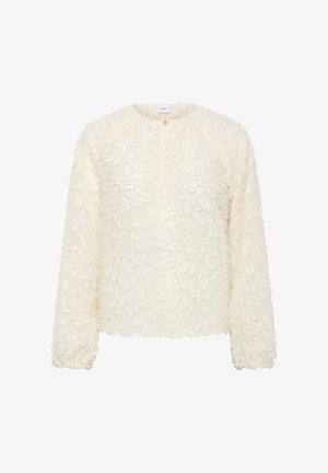 Blusa de manga larga de textura crema con cuello redondo y un pequeño botón de cierre en el centro delantero.