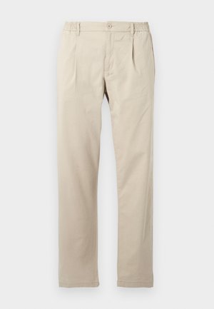 Light beige trousers made of cotton with a relaxed fit, featuring an elastic waistband, a front button closure, and straight legs.