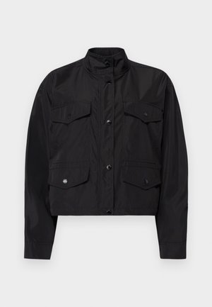 Black cropped jacket made of lightweight fabric. Features a high collar, front button closure, and two chest pockets with flaps.